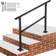 a set of stairs with handrails and screws on the side, next to a brick wall