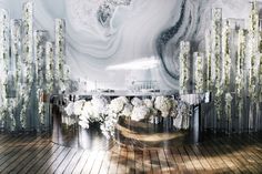 an artistic photo with white flowers in vases on a wooden floor next to a marble wall