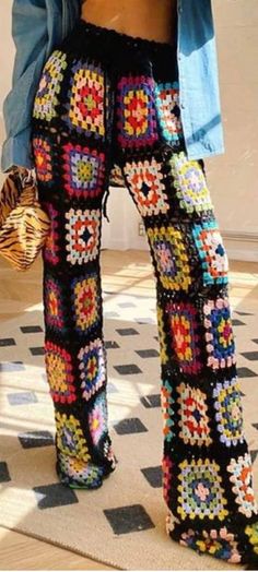 a woman is standing on the floor with her pants made out of crochet