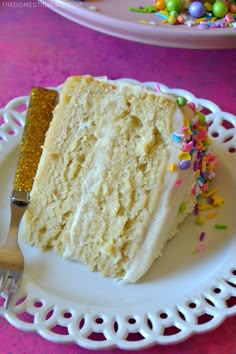 a slice of cake on a plate with sprinkles