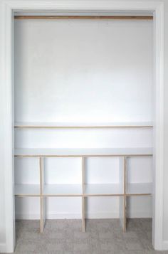 an empty room with white walls and shelves