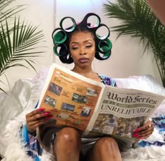 a woman with curlers on her head reading a newspaper