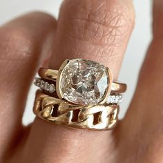 a close up of a person's hand with a ring on it and a diamond in the middle