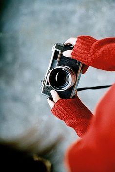 black and white photograph of a person holding a camera