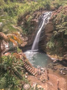 people are standing in front of a waterfall