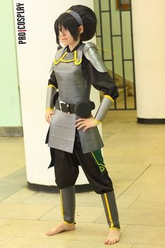 a woman dressed in an anime costume standing next to a wall