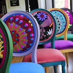 brightly colored chairs are lined up in a row