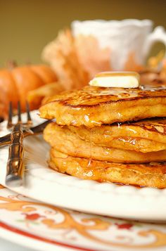 a stack of pancakes sitting on top of a white plate