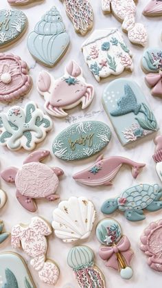 there are many decorated cookies in the shape of sea animals and fish on this table