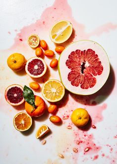 some oranges, lemons and other fruit are on the table with blood all over it