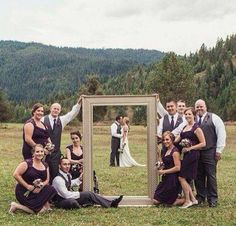 a group of people posing in front of a mirror