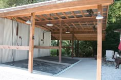 a dog is standing in front of a building with a covered patio and outdoor shower