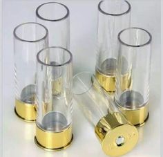 four clear glass vases with gold rimmed bases