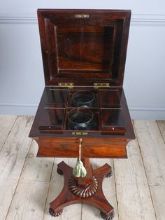 an old wooden box with two glasses in it