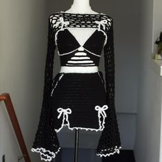 a black and white crochet dress on a mannequin