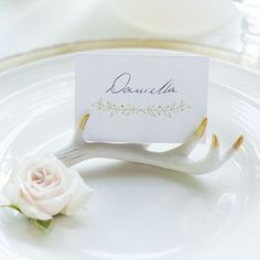 a place card holder on a white plate