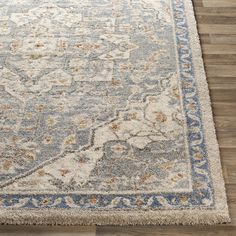 a large rug with an ornate design on the bottom and blue trimming around it