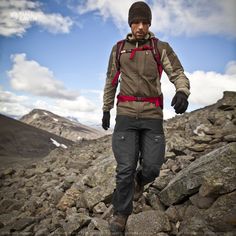 a man standing on top of a pile of rocks