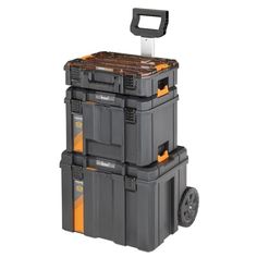 three large storage boxes stacked on top of each other with wheels and one holding a toolbox