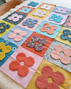 a table topped with lots of different pieces of fabric