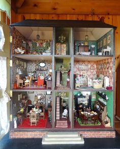 the inside of a doll house with furniture and accessories in it's display case