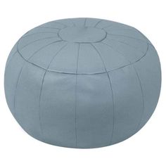 a blue leather poufle with an open top and round design on the bottom