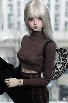 a doll with blonde hair wearing a brown sweater and black pants, holding a leopard print purse