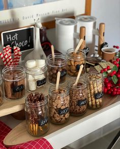 a table topped with jars filled with cookies and candy