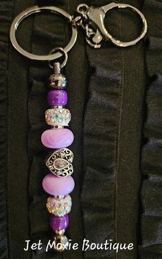 a close up of a key chain with beads on it