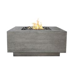 an outdoor concrete fire pit with flames on it's sides and the top lit up