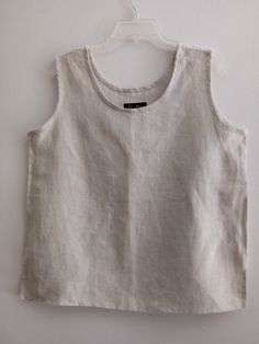 "Natural 100%  Linen/  casual tank top, scoop neck , side slits . Handmade from washed and soft medium weight. We wash and dry our products several times to achieve the maximum softness of the fabric and emphasize its natural structure. Armholes and neck with self  natural bias. Medium weight linen/rayon  Loose fit. Wide straps Soft and comfortable. Pre-washed / pre-shrunk Note that colors may look different on your display depending on their settings and technical characteristic SIZE MEDIUM : G Casual Flax Linen Tank Top, Neutral Cotton Tank Top, Everyday Neutral Linen Top, Summer Linen Tops With Scoop Neck, Summer Linen Top With Scoop Neck, White Linen Tank Top For Everyday, Casual Sleeveless Top With Natural Dye, Casual Sleeveless Eco-friendly Top, Scoop Neck Linen Top For Summer