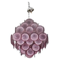 a pink chandelier hanging from a ceiling