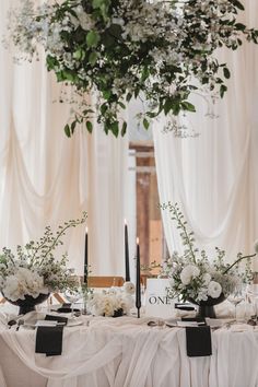 Wedding tablescape with black taper candles, frosted acrylic table number sign, classic black and white stationery and white drapes Black And White Aisle Decorations, Neutral Round Table Wedding, Rustic Luxe Wedding, Black White Rustic Wedding, Black Candle Tablescape, Romantic Black And White Wedding, Monochrome Tablescape, Black And White Wedding Tablescape, Black Candles Wedding