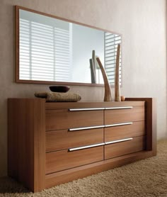 a wooden dresser sitting in front of a mirror on top of a carpeted floor