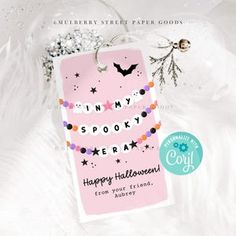 a pink tag with the words happy halloween on it