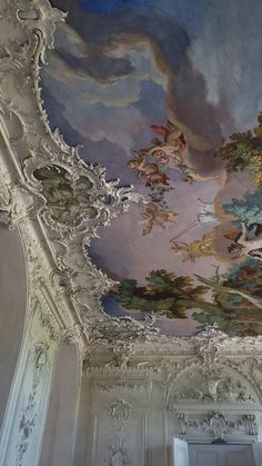 an ornate painted ceiling in a white room