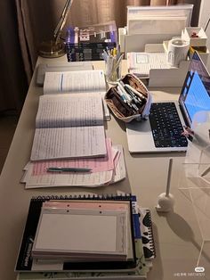 there are many books and papers on the desk