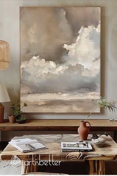 a painting hanging on the wall above a coffee table