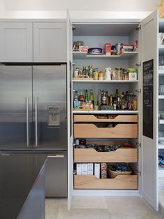 an organized pantry in a kitchen with stainless steel appliances