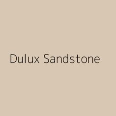 the words dulux sandstone on a beige background