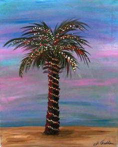 a palm tree with christmas lights on it in front of a blue and pink sky