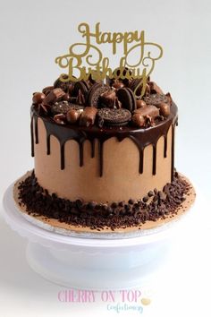 a birthday cake with chocolate frosting and cookies on top