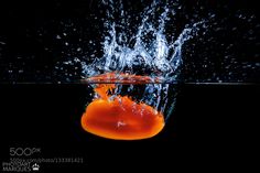 an orange jellyfish splashing into the water