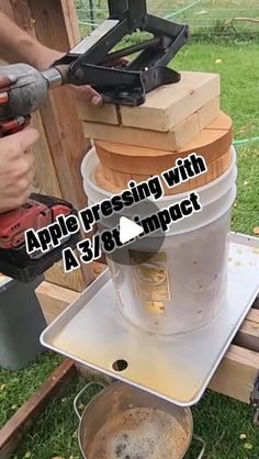 a person using a power drill to fix an apple cider