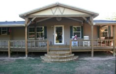 a man sitting on a porch in front of a house with steps leading up to it