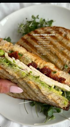 a person holding a sandwich in their hand on a white plate with text overlay