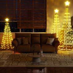 a living room with christmas lights on the walls and couches in front of it