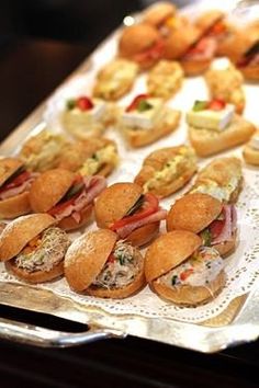 small sandwiches are lined up on a tray