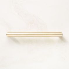 a gold handle on a white wall