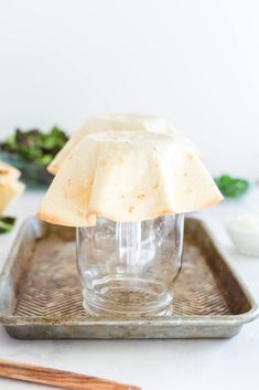 a glass jar with some food in it on a tray